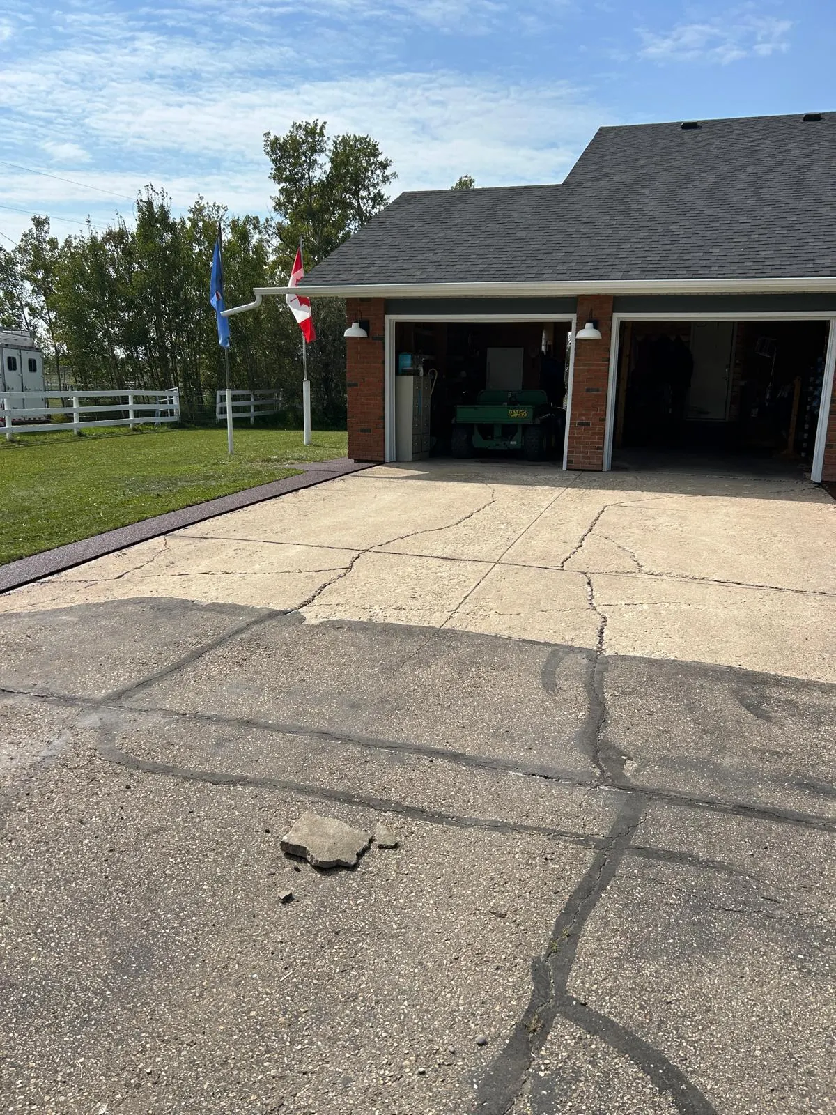 Before: the acreage driveway in plain cracked concrete, prior to the rubberized resurfacing